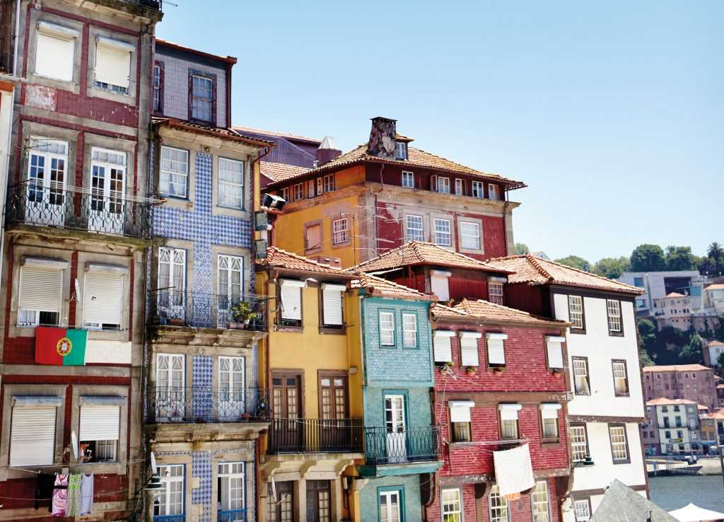 Colourful terraced houses line historic Ribeira Square on the banks of the Rio Douro in Porto.