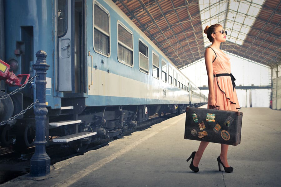 woman-with-suitcase-train-platform